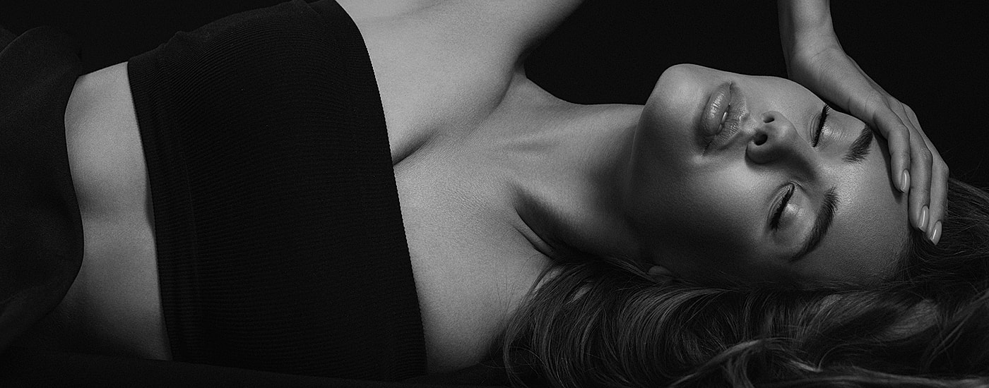 Black and white portrait of a woman reclining.