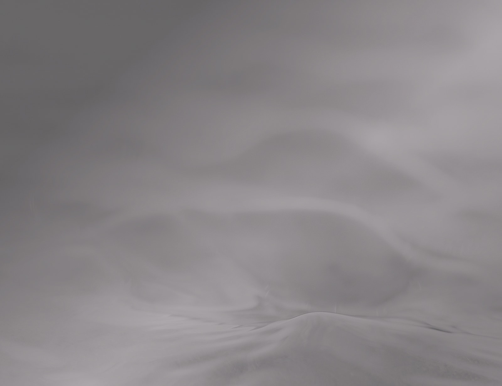 Abstract gray surface with soft curves.