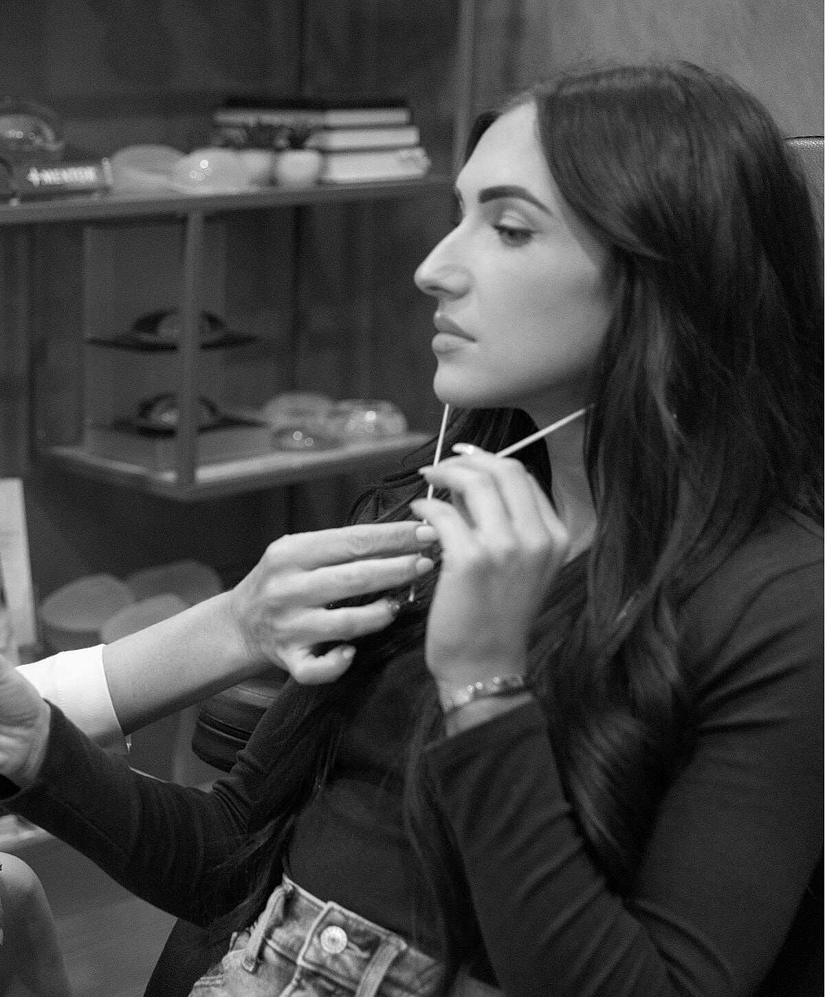 Woman receiving treatment with hands adjusting device.