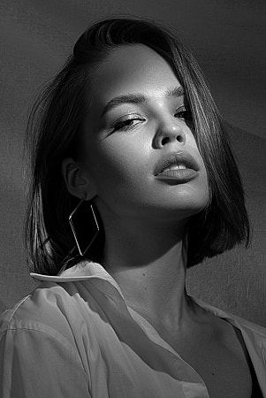 Woman with short hair in dramatic lighting.