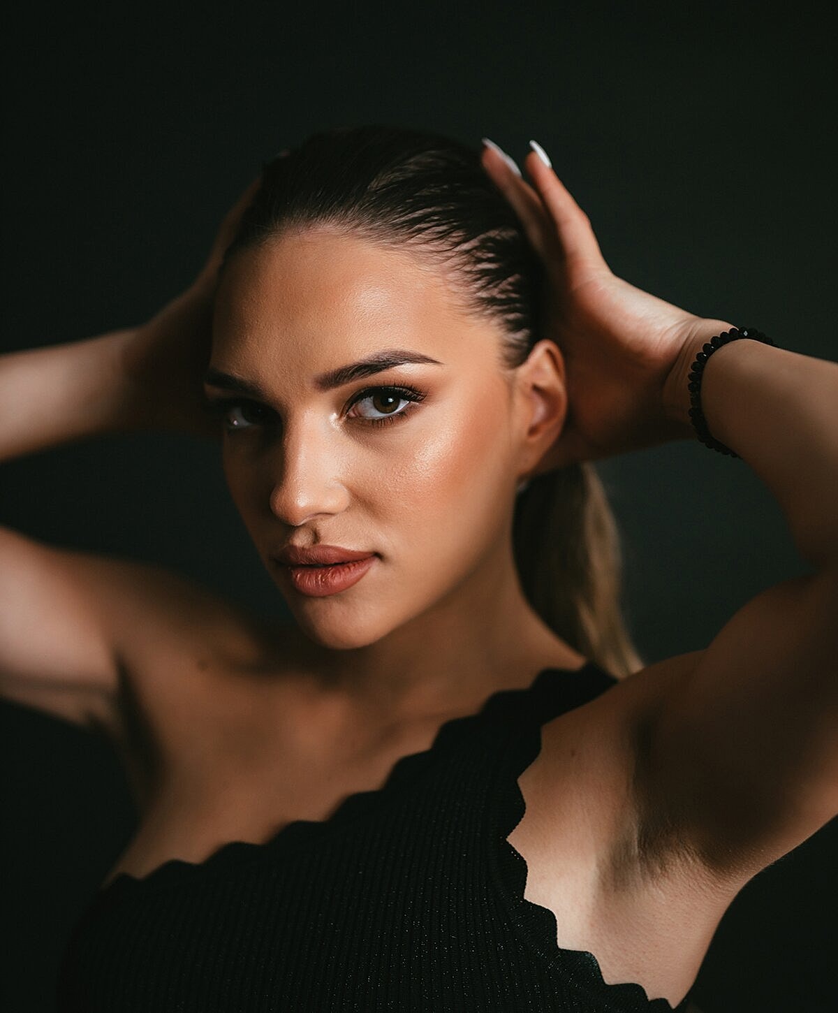 Portrait of a woman with sleek hairstyle.