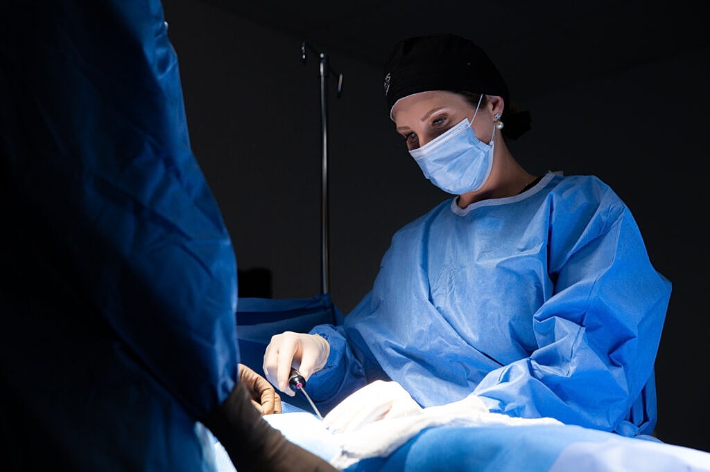 Surgeon performing a procedure in a hospital.