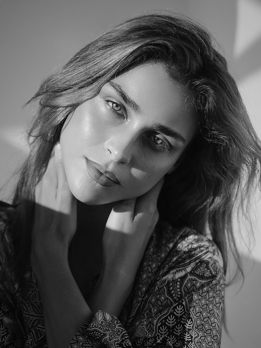 Black and white portrait of a contemplative woman.