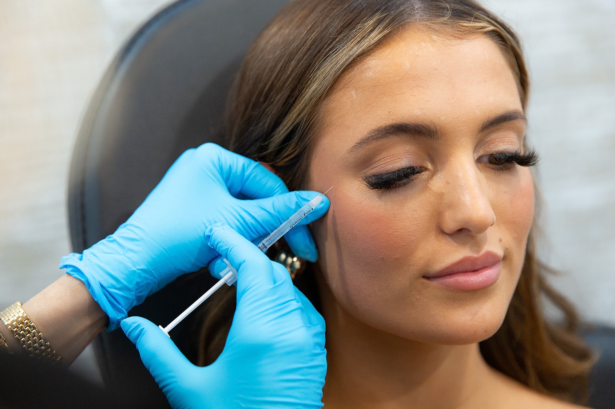 Medical professional administering cosmetic treatment.