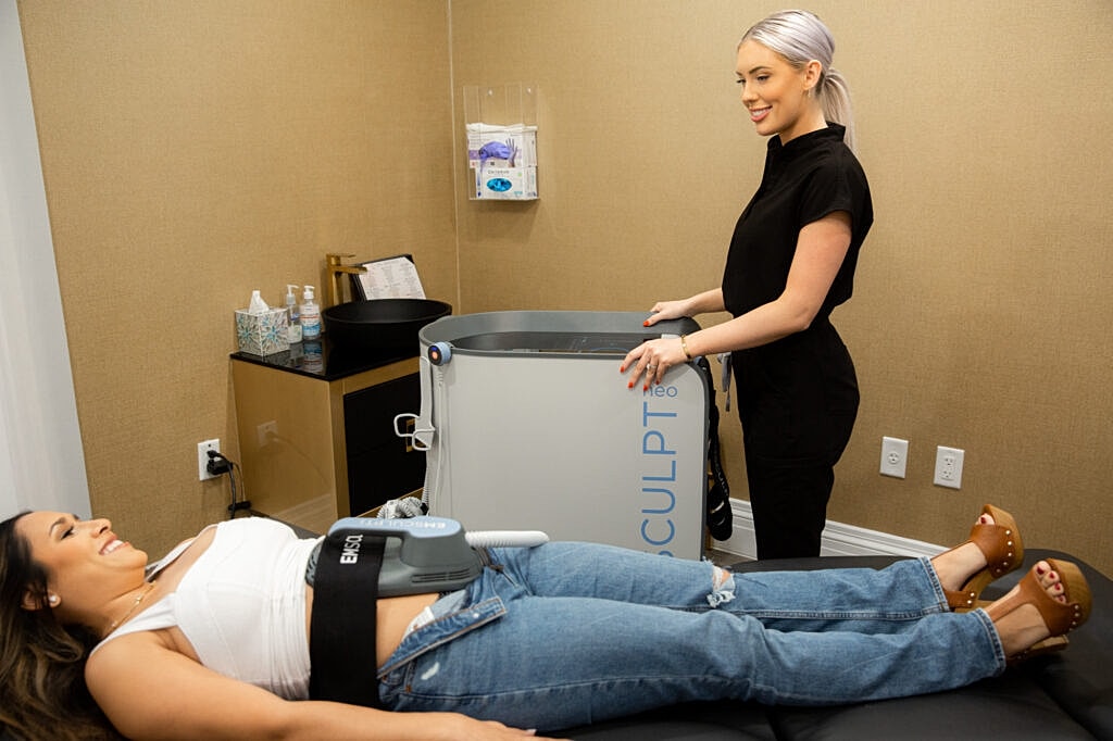 Client receiving body sculpting treatment at clinic.