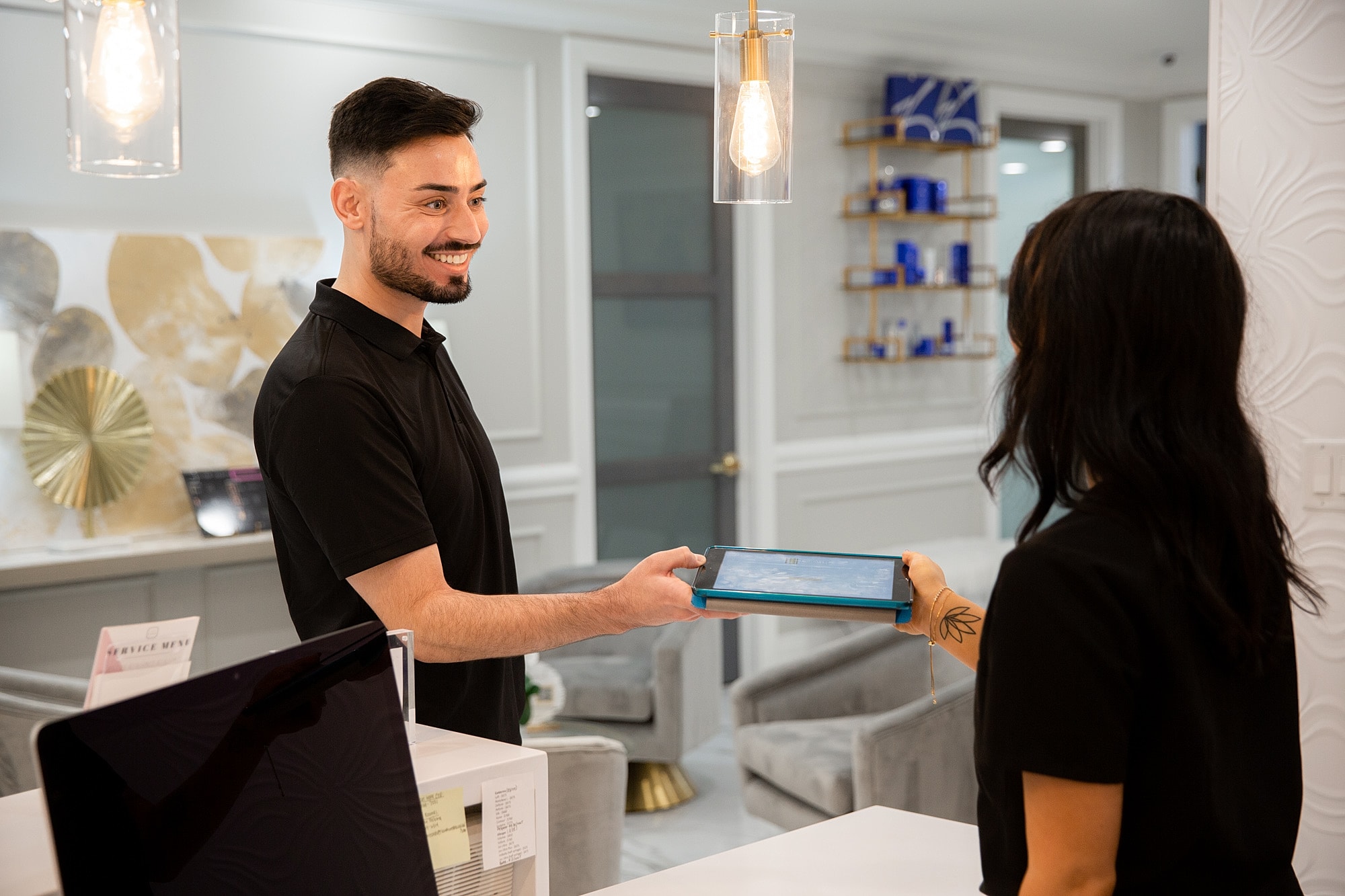 Client receiving a tablet from a staff member