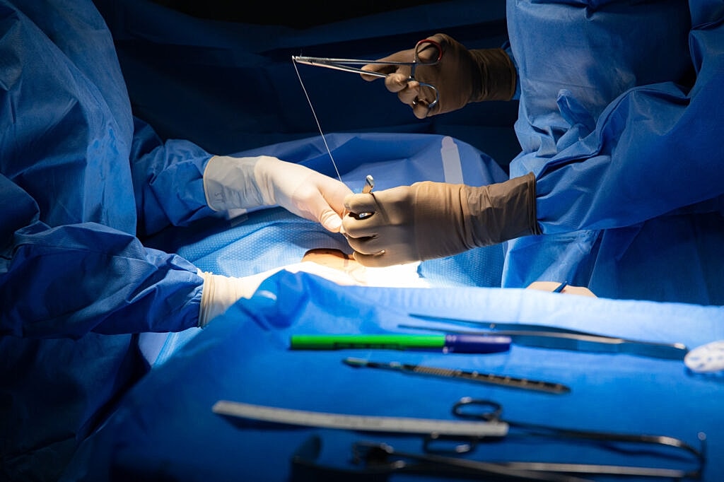 Surgeons performing a procedure in a sterile environment.