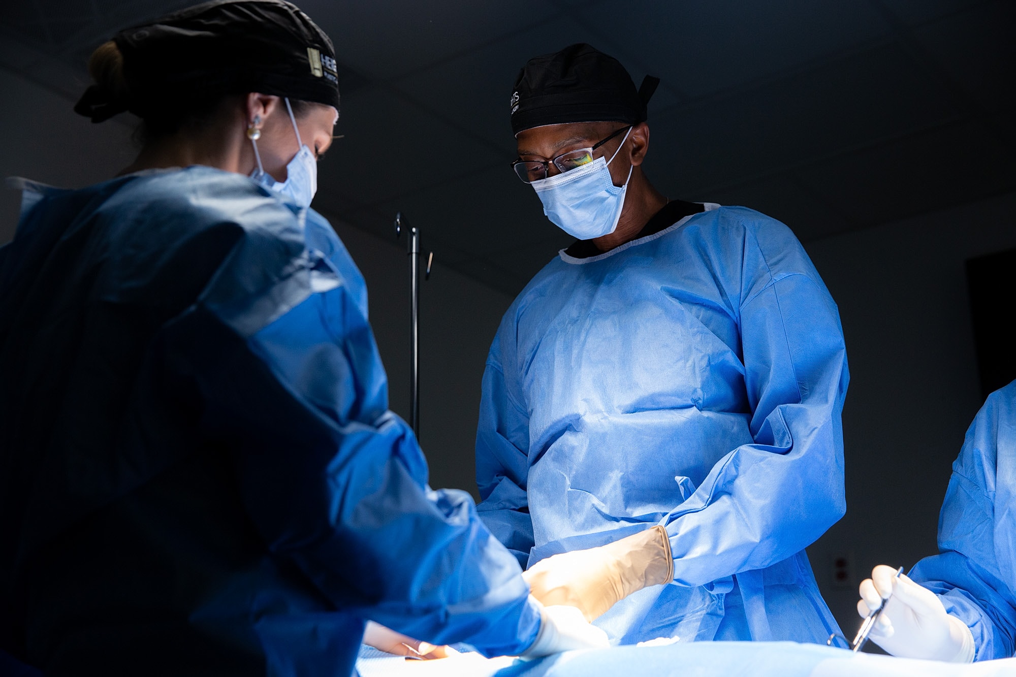 Surgeons performing surgery in an operating room.